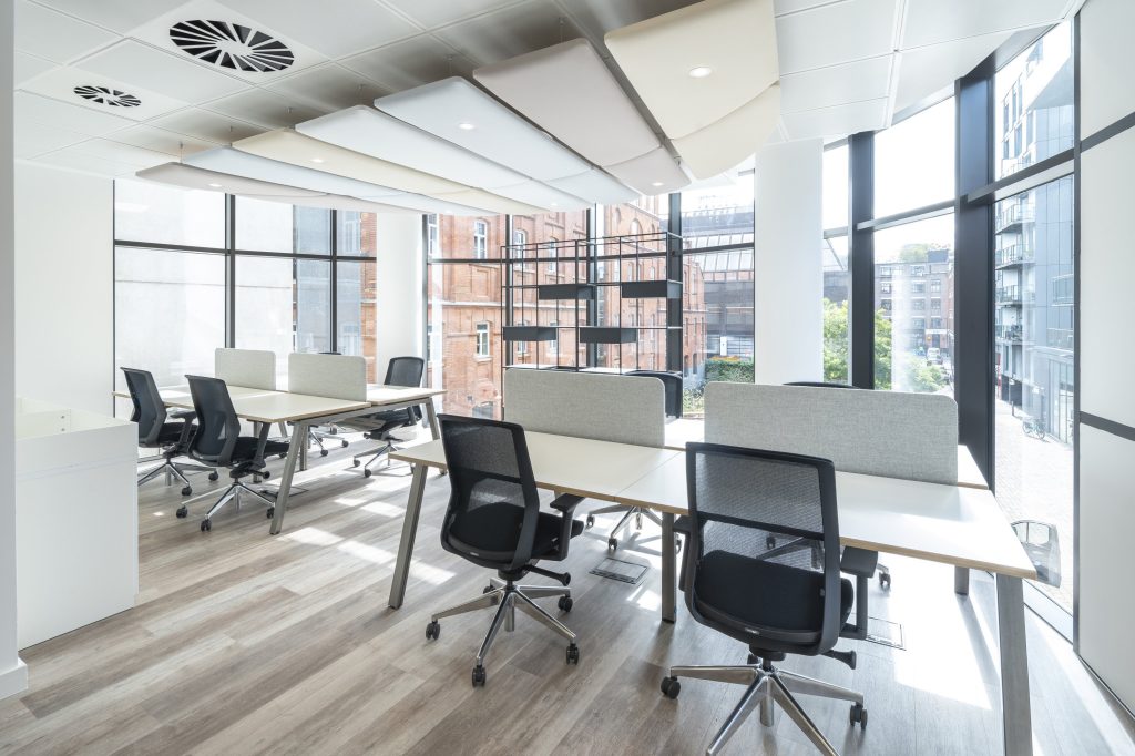 Newly refurbished office space in The Poppy Building, located in Brewhouse Yard, London's Tech Hub, featuring floor-to-ceiling windows and a communal roof terrace.