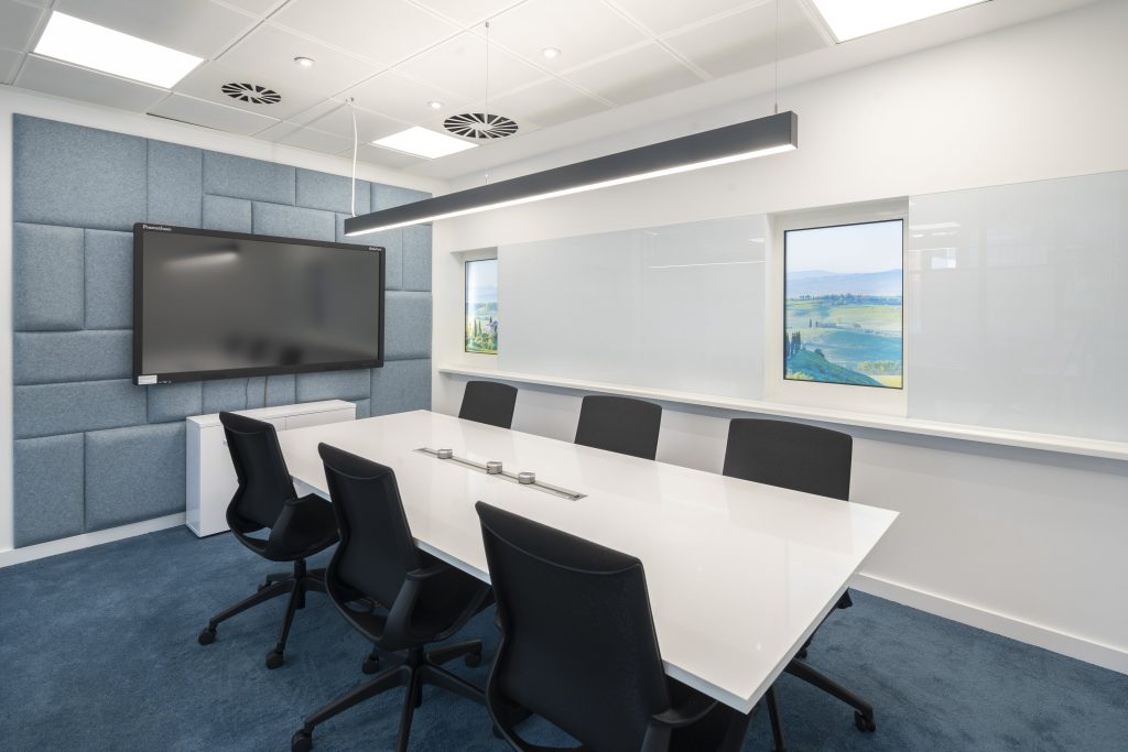 Newly refurbished office space in The Poppy Building, located in Brewhouse Yard, London's Tech Hub, featuring floor-to-ceiling windows and a communal roof terrace.