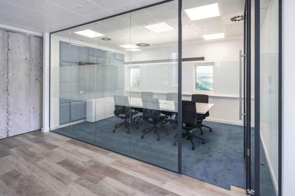 Newly refurbished office space in The Poppy Building, located in Brewhouse Yard, London's Tech Hub, featuring floor-to-ceiling windows and a communal roof terrace.