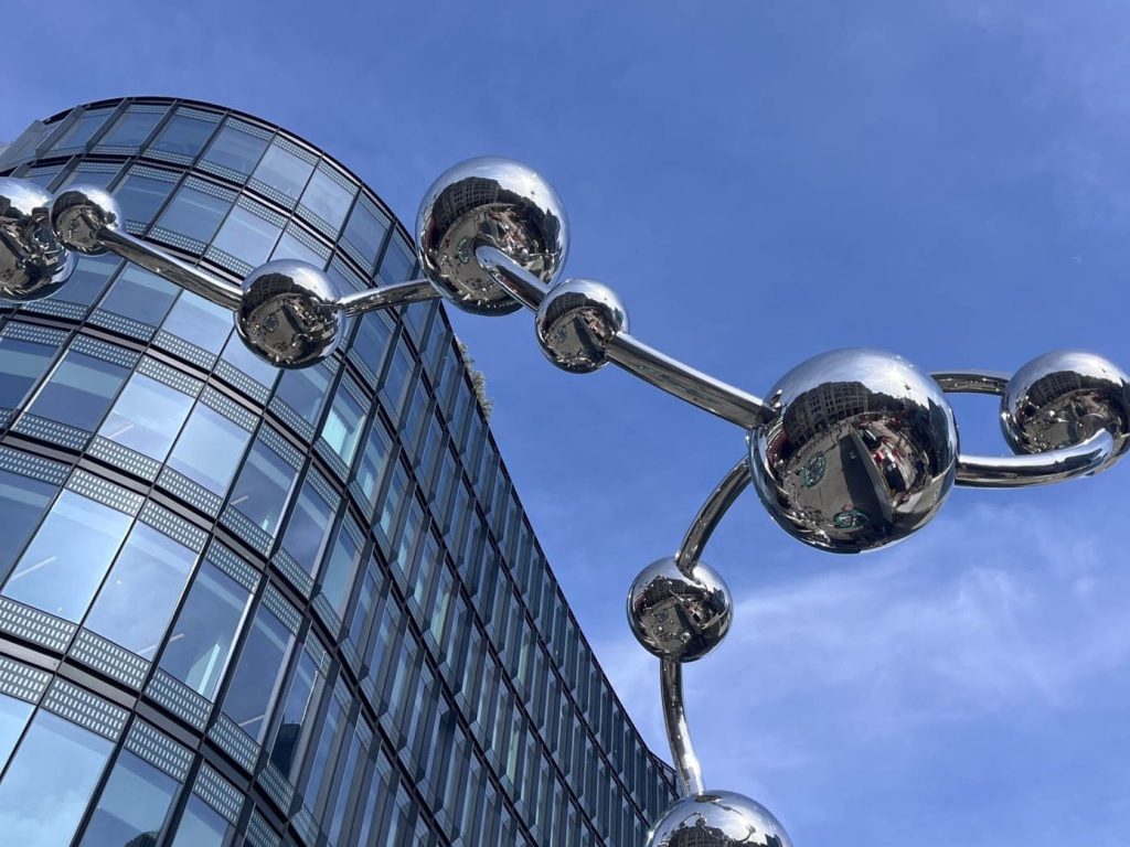Near London liverpool street, curved building with flexible silver sculpture.